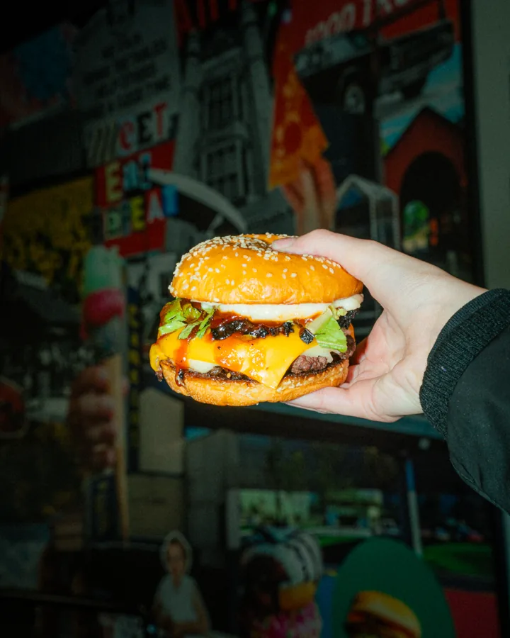 Classic double smash held up in front of the Canteen mural